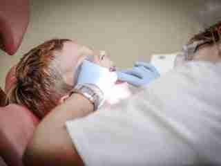 your mouth: child on a dentoists chair being examined